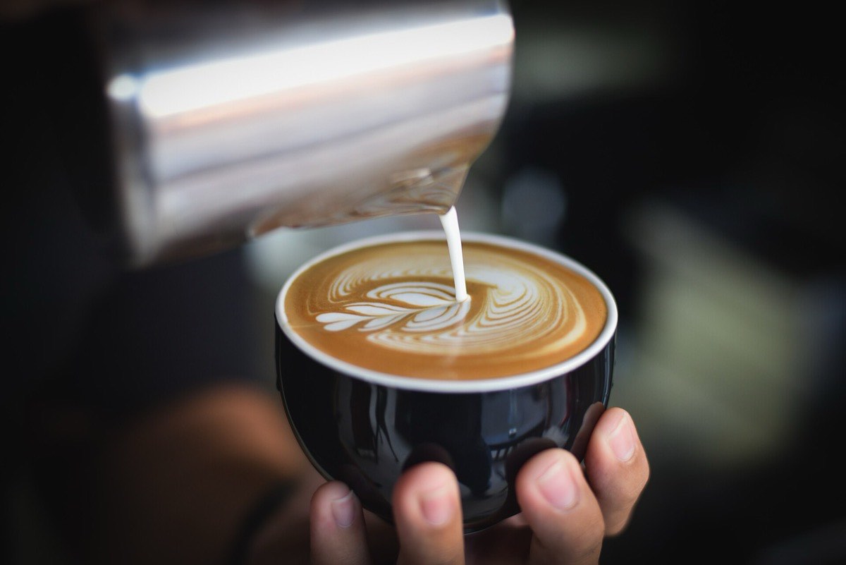 A fresh cup of coffee at a cafe table