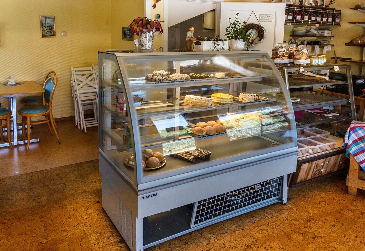 Bakery case stacked with cakes and pastries